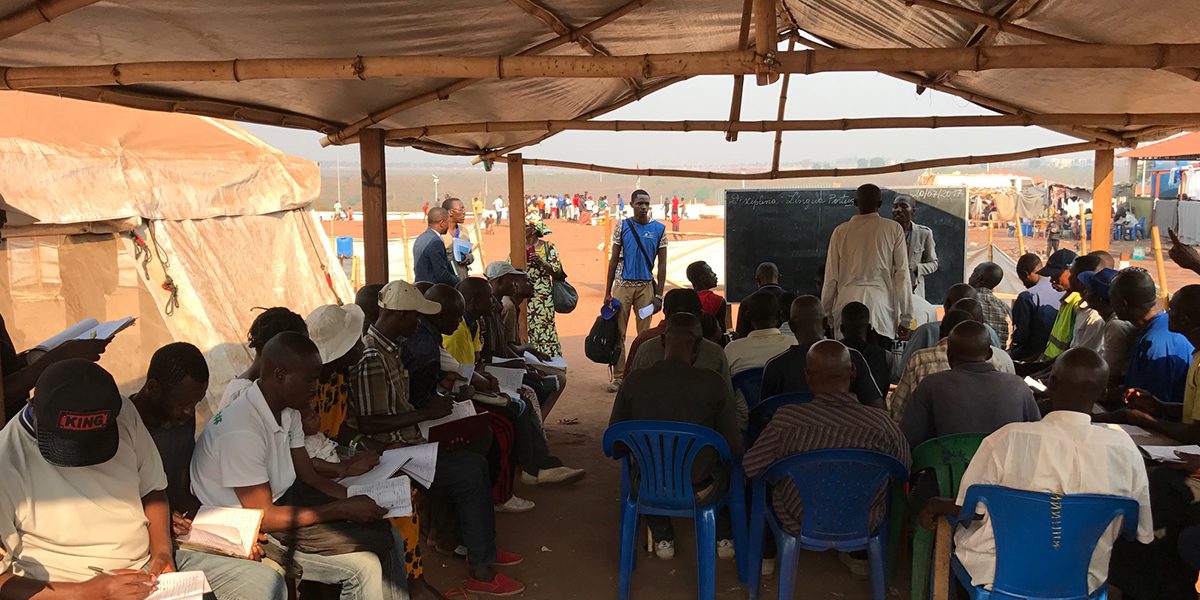 Adult students attending a class in a camp on the outskirts of the city of Dundo, Lunda Norte.