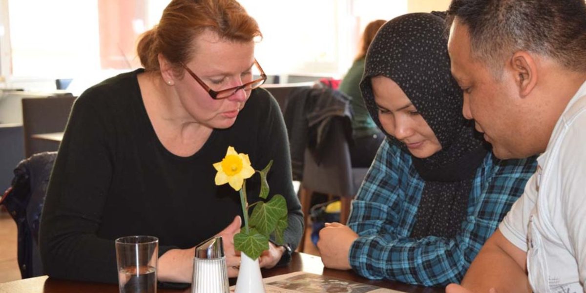 Two refugees receive language tutoring. (Jesuit Refugee Service)